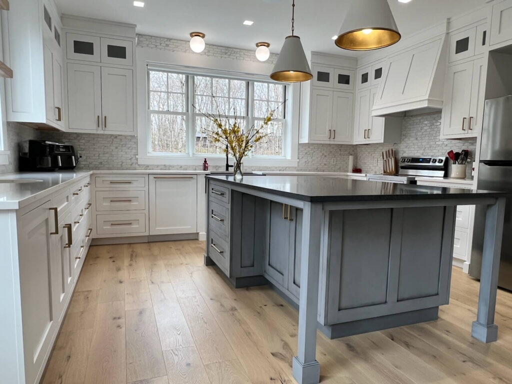 Shot of an island table and kitchen from the recent custom cabinet project in Quispamsis, New Brunswick.