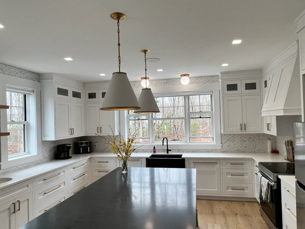 Shot of an island table and kitchen from the recent custom cabinet project in Quispamsis, New Brunswick.