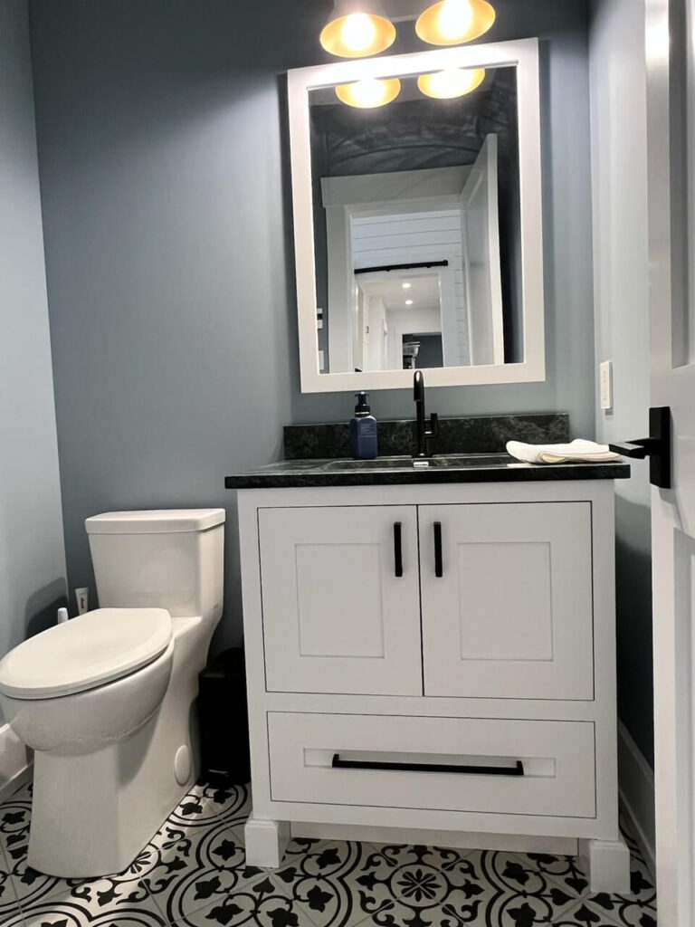 Shot of bathroom sink and toilet from the recent custom cabinet project in Quispamsis, New Brunswick.