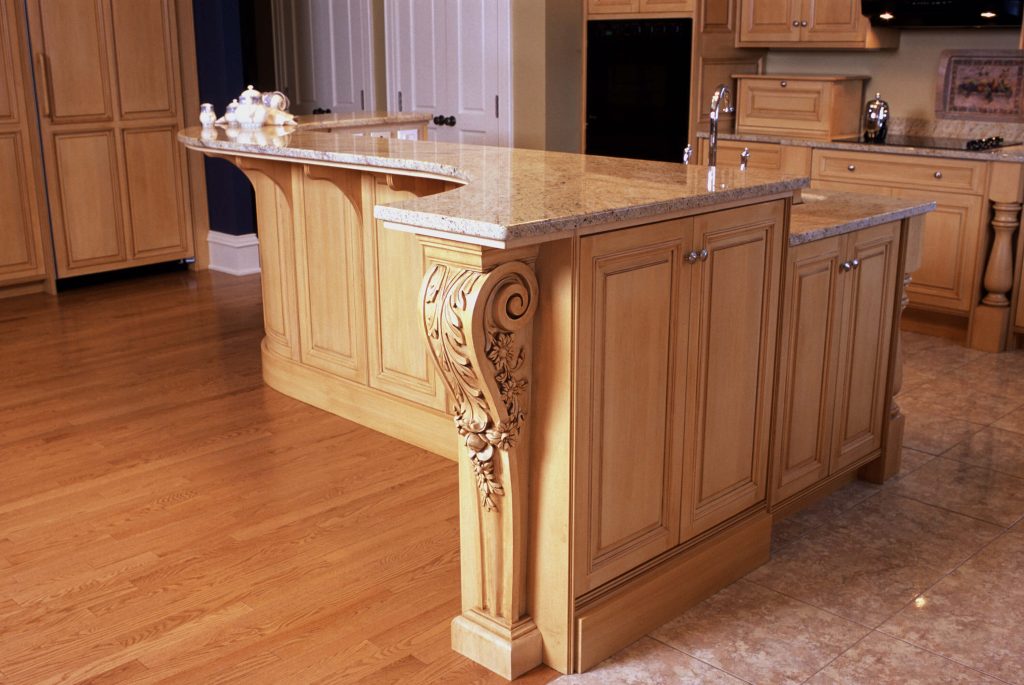 Maple island with a hand-carved corbel and granite top