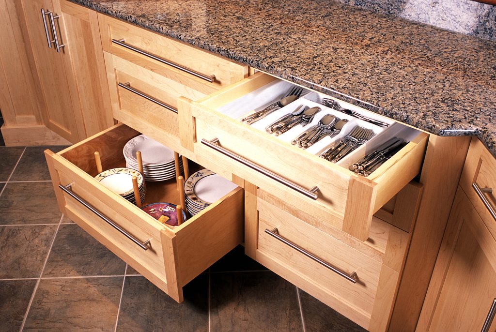 Maple drawers opened to show dish and cutlery storage